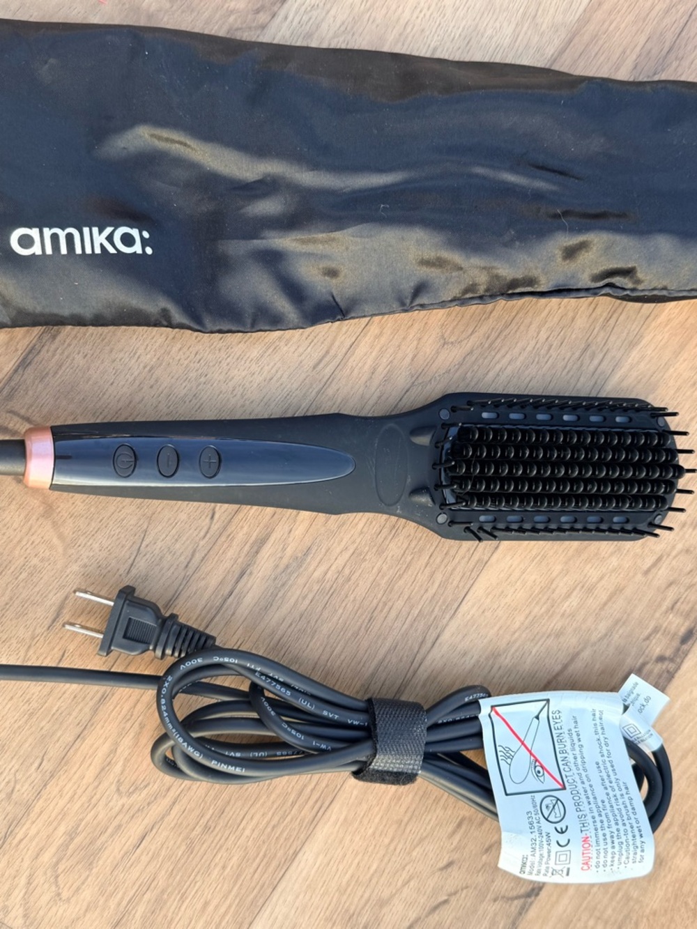 amika Black Straightening Brush with Rose Gold Logo